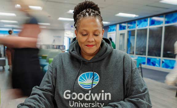 student studying wearing a Goodwin University sweatshirt